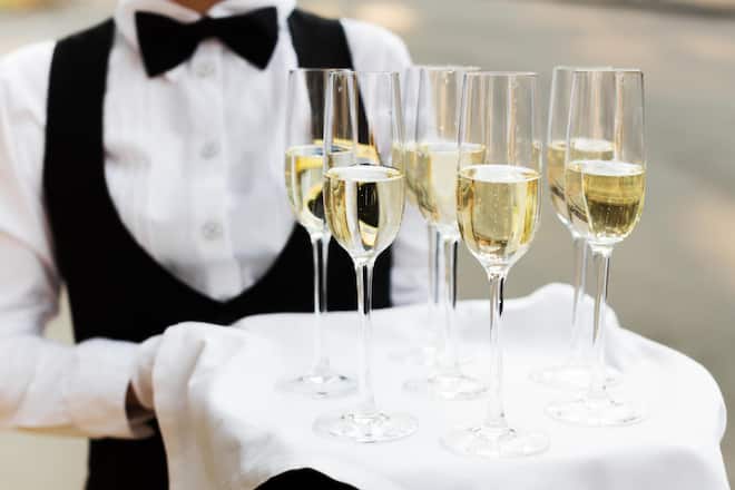 Full glasses of champagne on tray