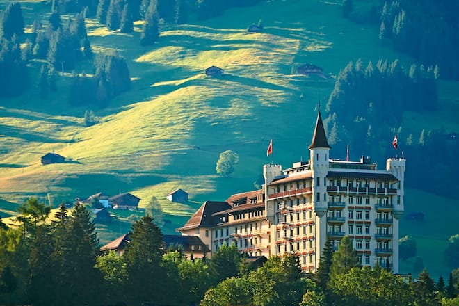 Sonnenaufgang im sommerlichen Gstaad mit dem Gstaad Palace 5* Superior Hotel. Swiss Deluxe Hotels AussenansichtÂ