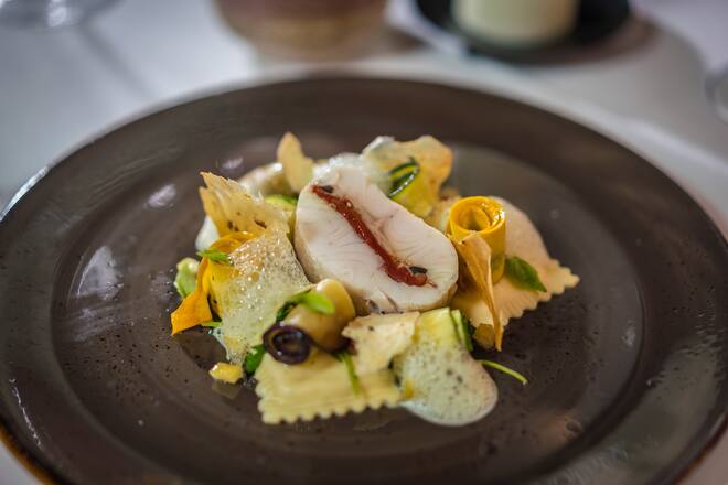 Foto: Joseph Khakshouri 12.08.2019Zum HirschenNadja Schuller (Küchenchefin)Stephane Wirth (Gastgeber)Konfierter Zander gespickt mit Tomaten und Oliven an Jus und Basilikumschaum mit Limetten.Ricotta Ravioli, Antipasti und Pinienkernen Villigen (AG)