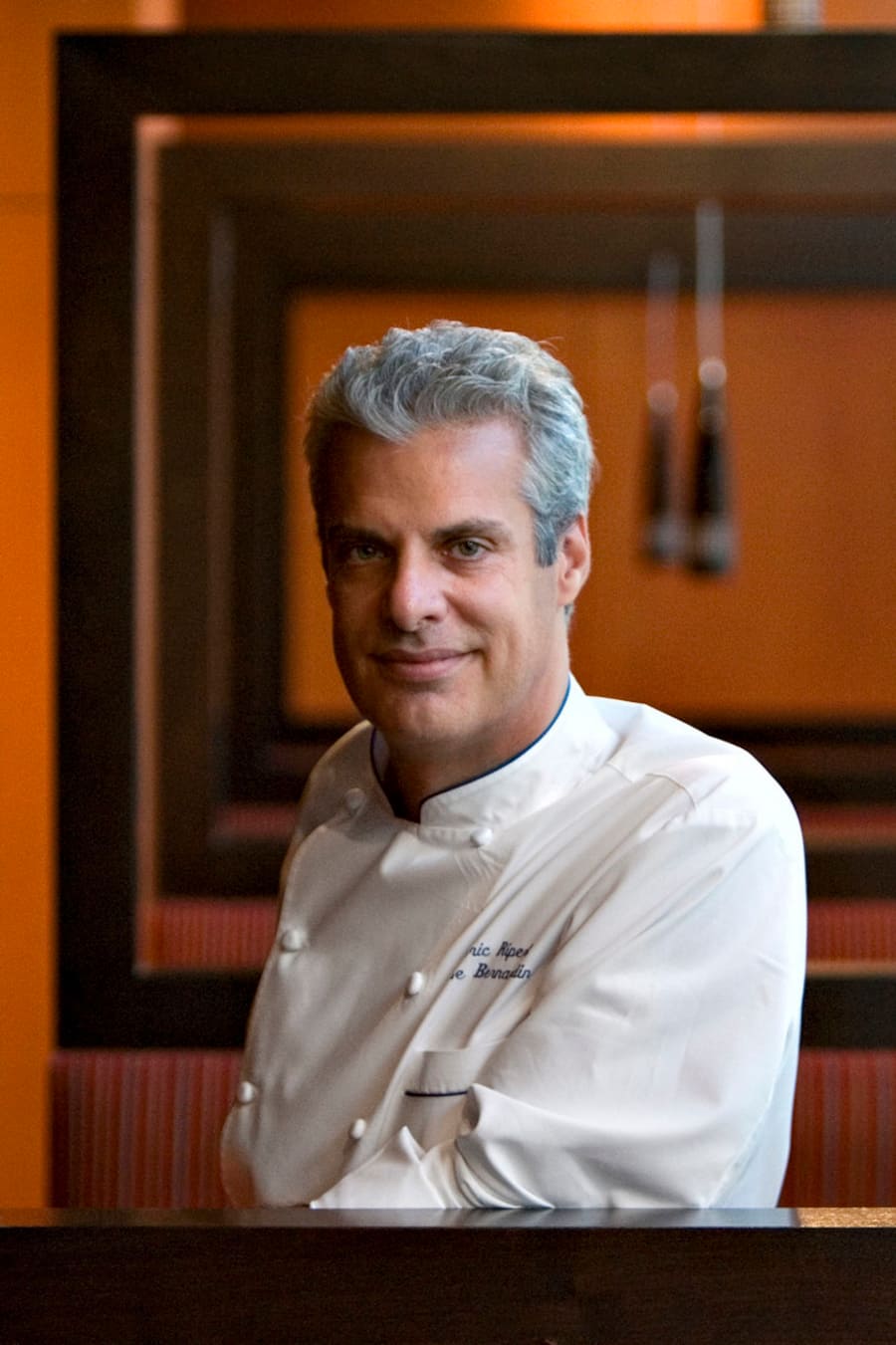 FILE- This Monday, Oct. 15, 2007 file photo shows chef Eric Ripert as he stands in his restaurant, West End: A Bistro by Eric Ripert, at the Ritz-Carlton Hotel in Washington. For APâs 20 Salads of Summer series, Eric Ripert offered a recipe he created while visiting Vietnam. It blends crunchy, tart green papaya with shrimp and calamari, then dresses everything with fresh mint and cilantro and a splash of lime juice and pungent fish sauce. (AP Photo/J. Scott Applewhite)