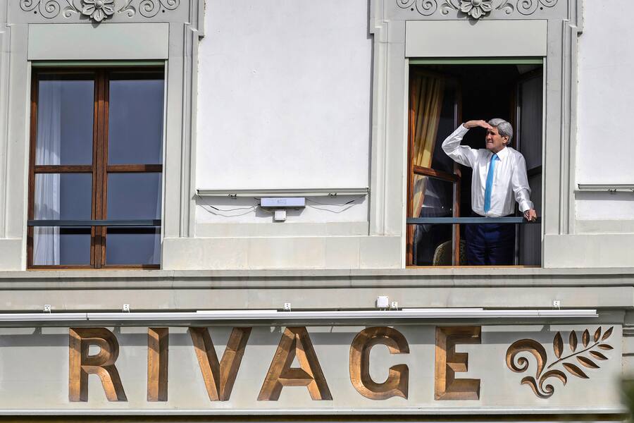 US Secretary of State John Kerry looks out of the window of his room at the Beau-Rivage Palace hotel during a break in Iran nuclear talks in Lausanne, Switzerland, on April 1, 2015. Iran's chief nuclear negotiator Abbas Araghchi said on April 1 that "problems" remain in nuclear talks with world powers and that there can be no deal without a "framework for the removal of all sanctions". AFP PHOTO / FABRICE COFFRINI / AFP / FABRICE COFFRINI (Photo credit should read FABRICE COFFRINI/AFP via Getty Images)