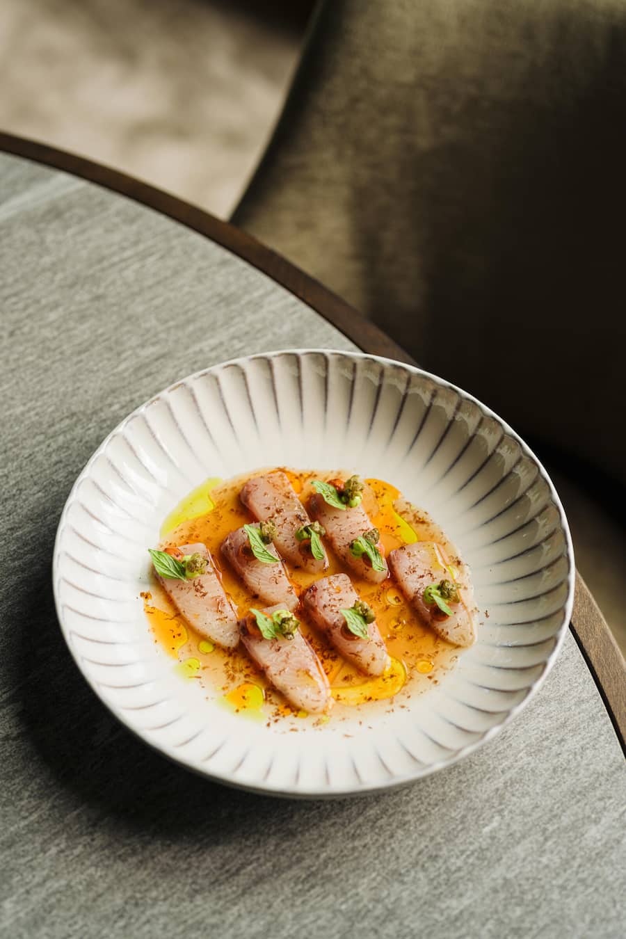 KING FISH CRUDO tomato, capers, taggiasca, olives, oregano Food - The View - Grace St. Moritz - Copyright Olivia Pulver - 12/2023