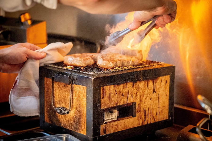 Chef using a Konro Japanese BBQ Grill