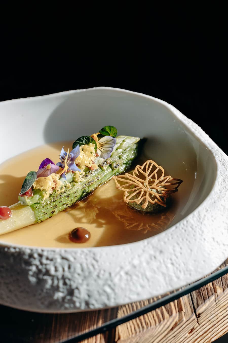 Asperge verte, café fermenté et consommé aux épices: une assiette qui illustre parfaitement la philosophie des lieux.