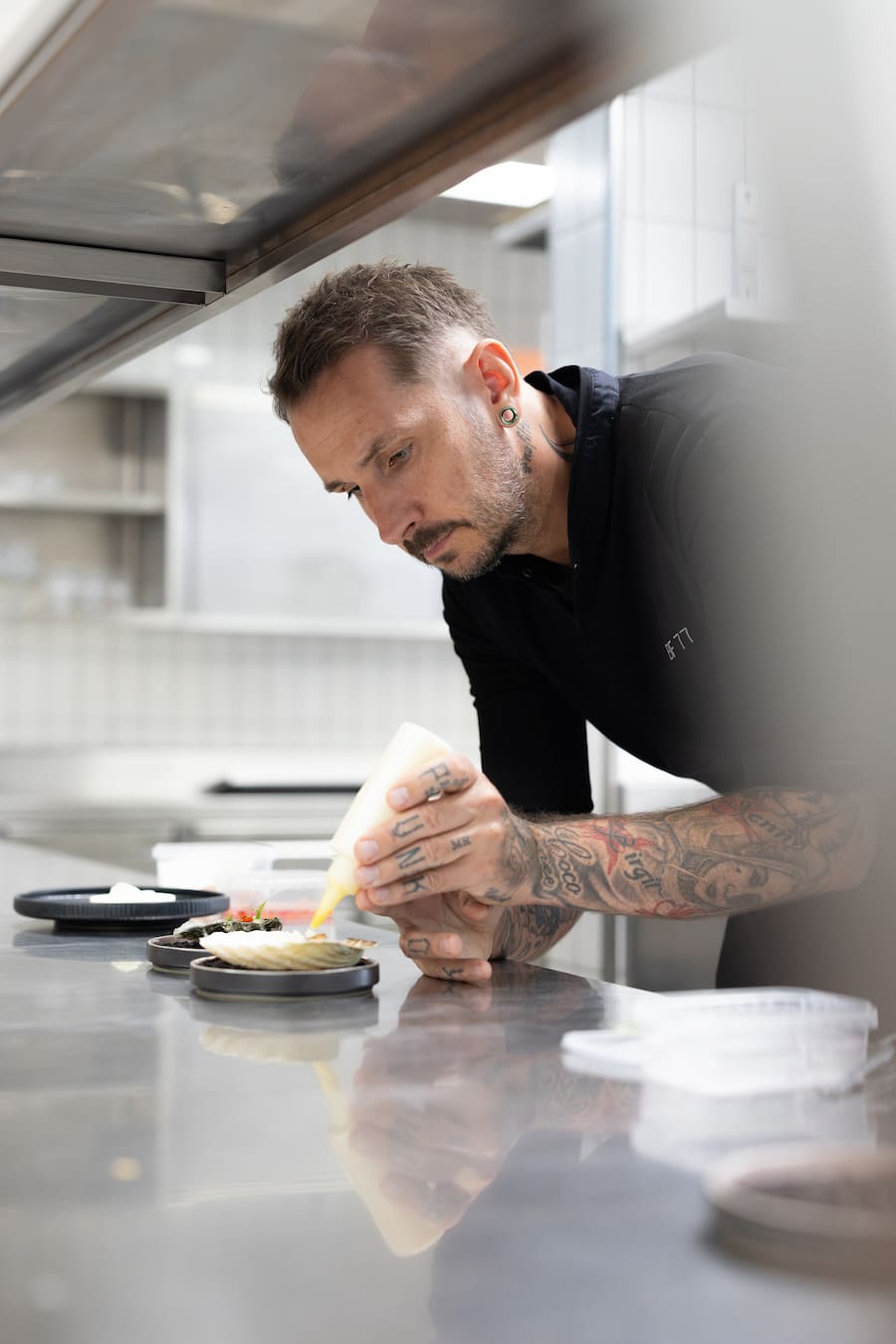 Bernd Fabian, Koch, am anrichten eines Gerichts aus roher Jakobsmuschel mit Schnittlauch und einer Vinaigrette, 13. August 2025, Hotel Chasa Montana Samnaun, Copyright: Simone Lombard