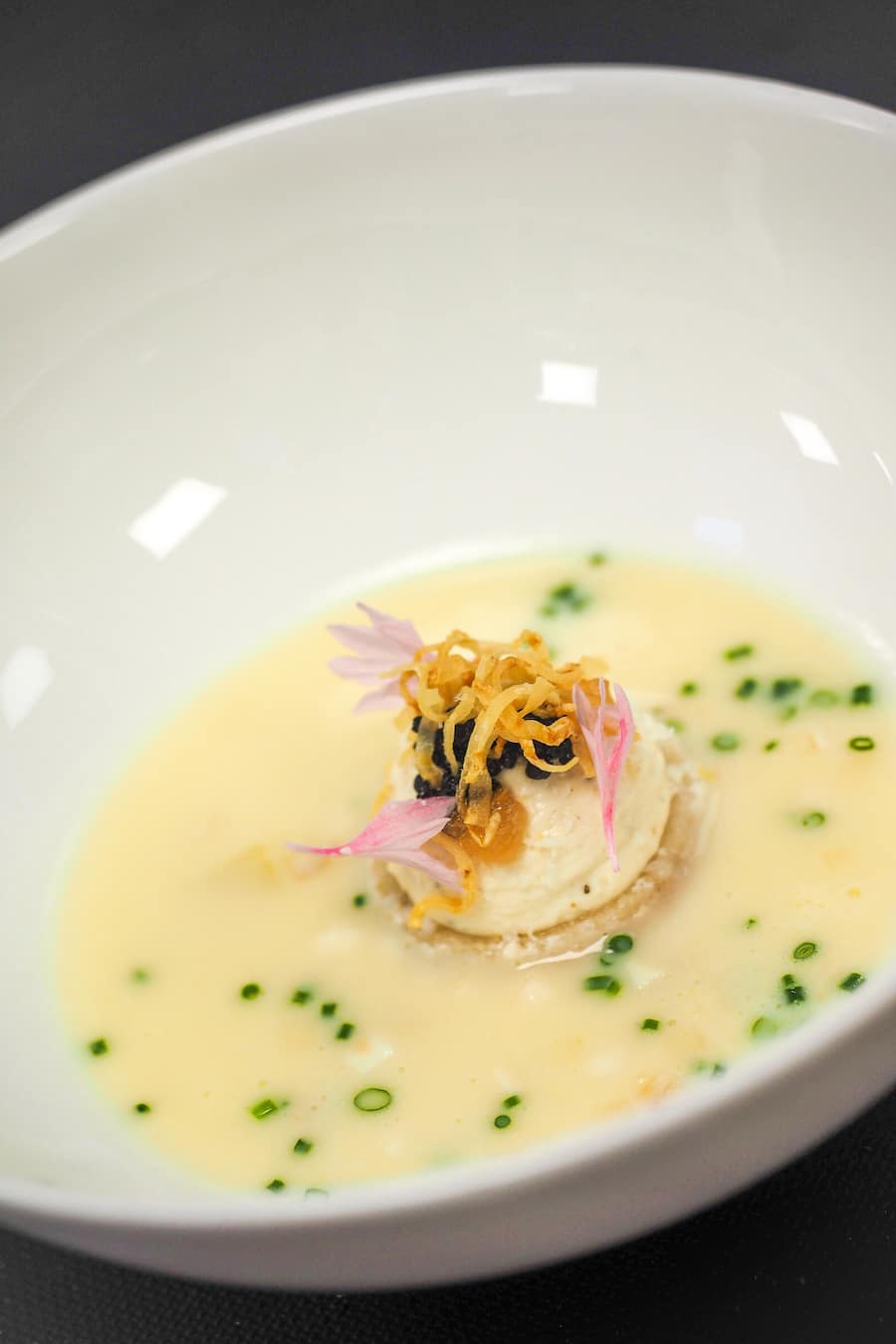 Champagnersüppchen mit Sellerie-Apfelwürfel & schwarzem Knoblauchkaviar.