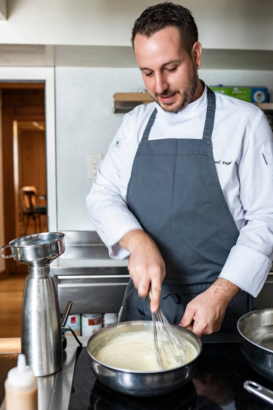 Zwyssighaus, in Bauen UR, Michael Engel bereitet purierte Hörnli mit Ghackets und Apfelmus zu